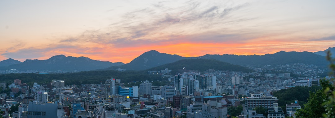 a view of a city with mountains in the background