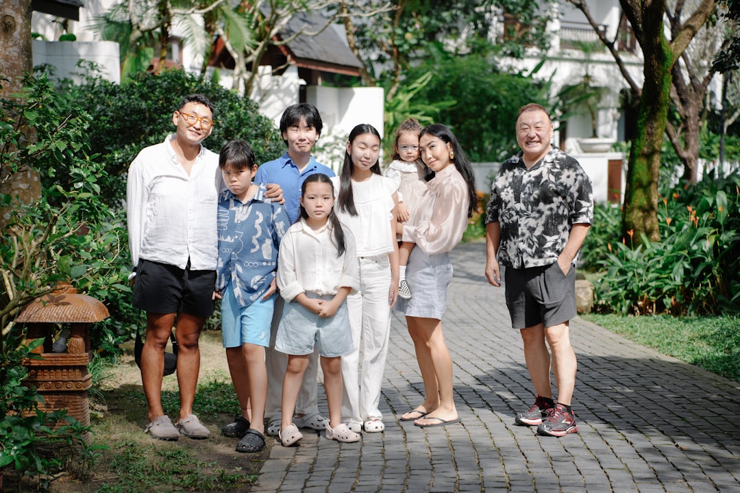 A family poses for a group portrait outdoors.