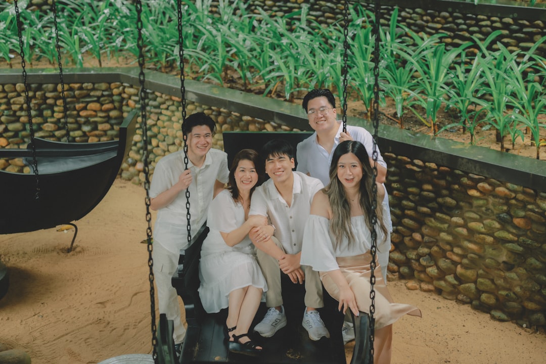 Family posing for a picture on a swing.