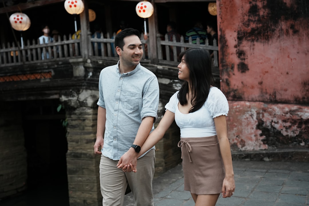 Couple walking hand-in-hand near lanterns