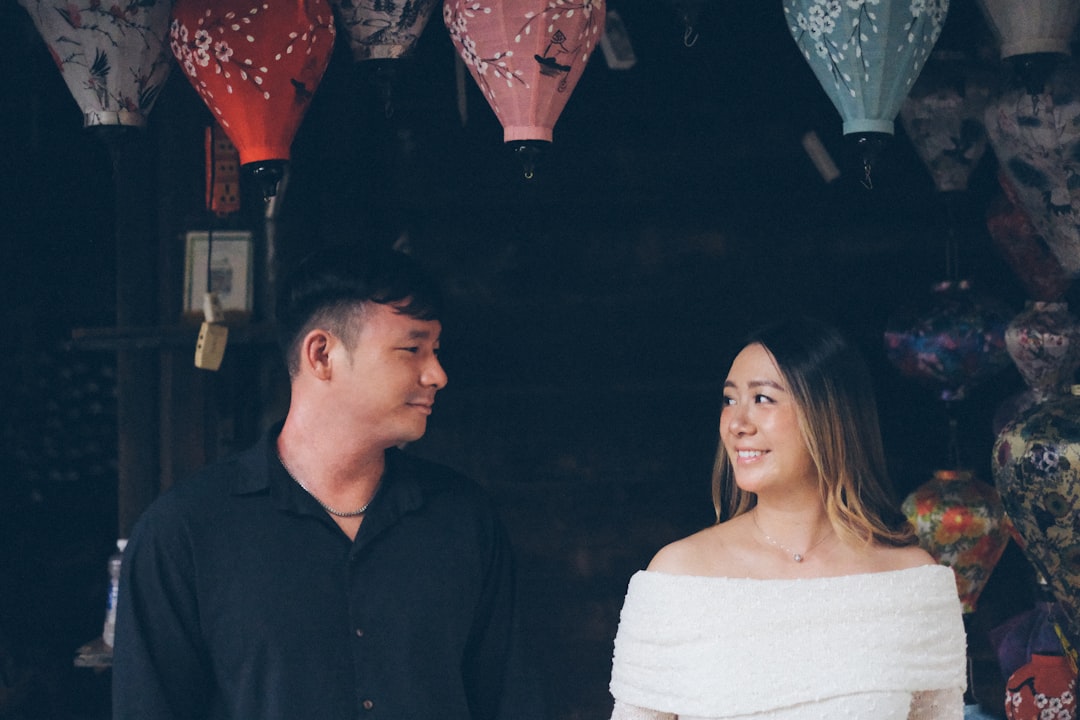 Couple looking at each other under lanterns