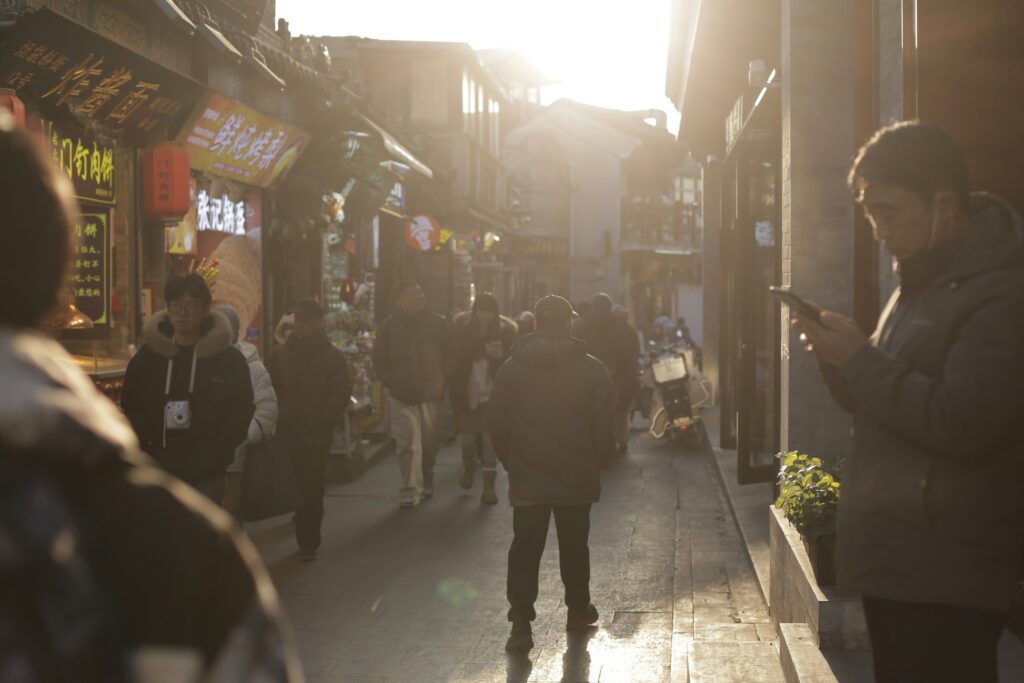 friends learning Korean online on laptop in busy city street, natural light, realistic high quality photo